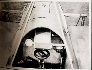 Caption: A view can be seen of the control wheel in front of which is a map holder. On the right is a compass. 