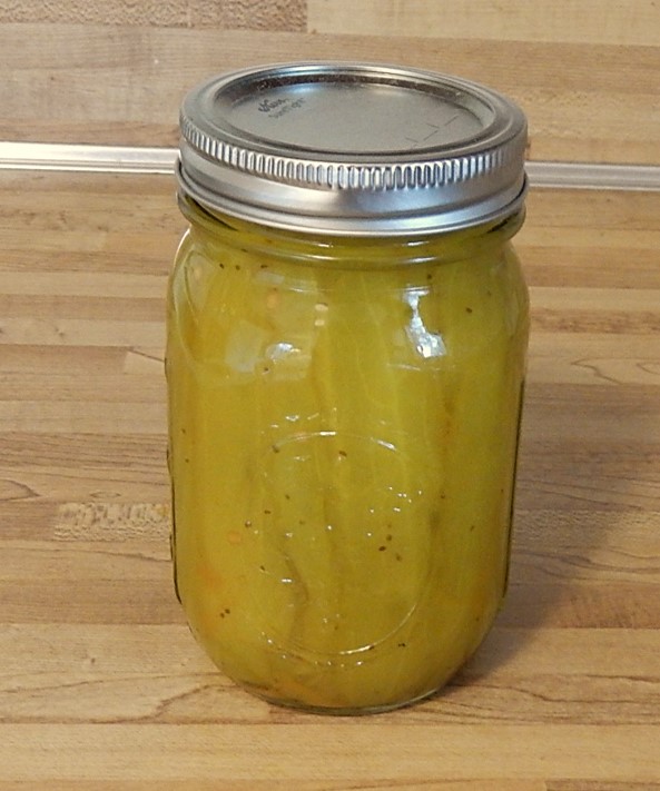 pint canning jar filled with sweet cucumber pickle strips