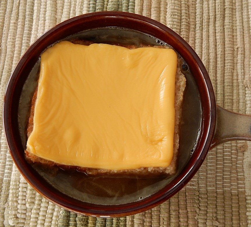 bowl of French Onion Soup with toast and cheese on top