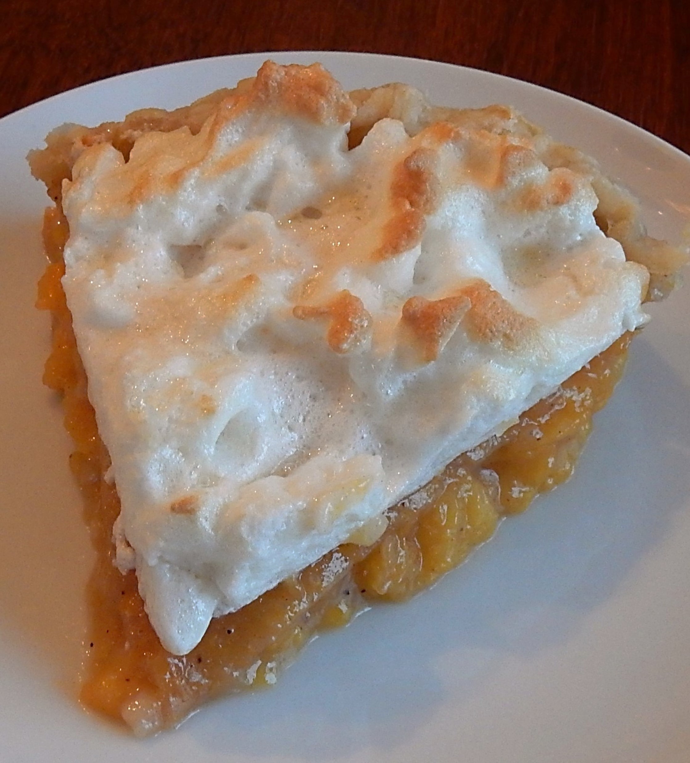 slice of peach pie with meringue