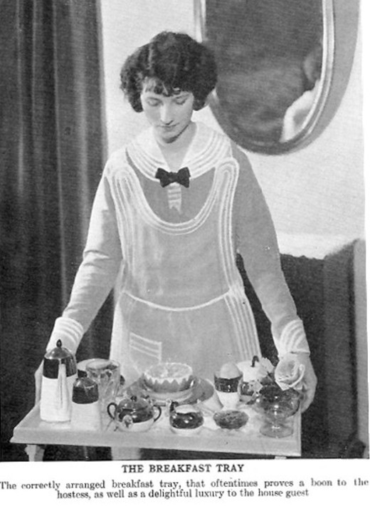 Woman carrying a tray with food.