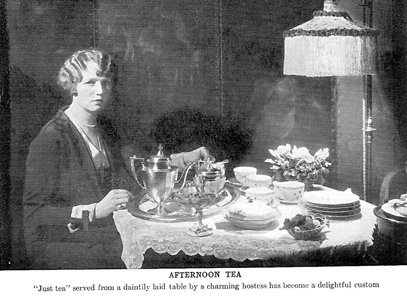 Woman by table set for tea